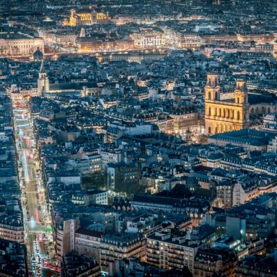 View of a bustling city skyline at night with numerous illuminated buildings, Paris, France