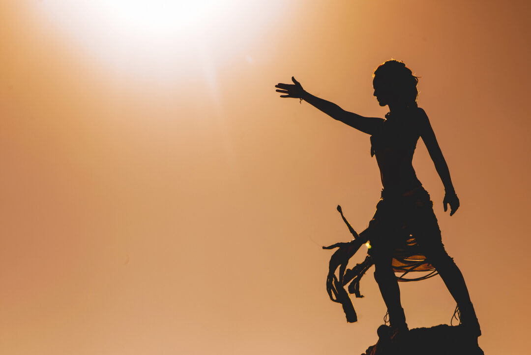 silhouette-of-woman-standing-with-arm-raised-2026-01-11-08-51-40-utc