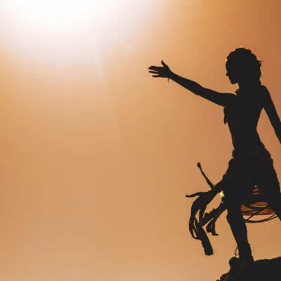 silhouette-of-woman-standing-with-arm-raised-2026-01-11-08-51-40-utc